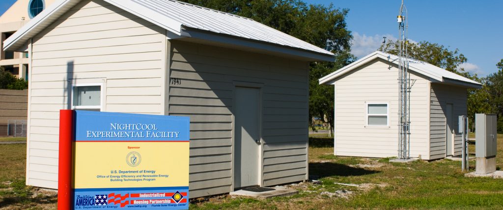 Two small buildings similar to the size of a shed, configured with different roof materials.