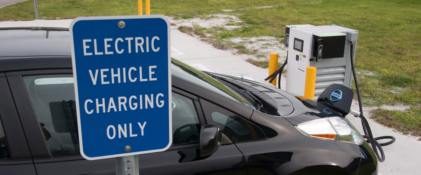 Electric vehicle charging only sign with Nissan LEAF and charging station evtc