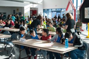 School children discussing their answer at the Middle School Science Bowl