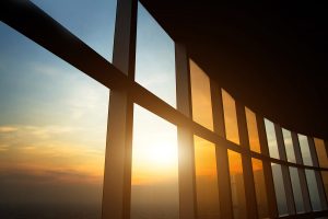Large window panes with sun shining through.