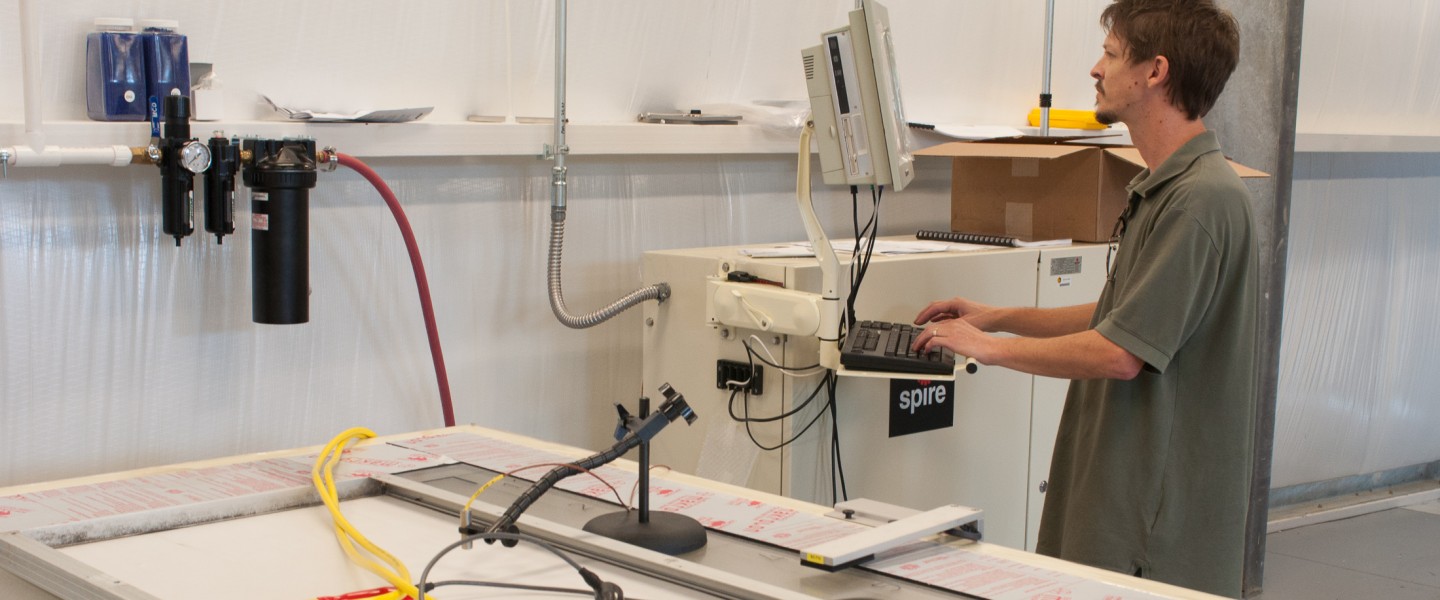 Researcher tests photovoltaic module on Spire solar simulator.