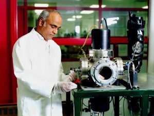 Dr Dheer inspecting thin film pv in a lab