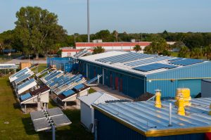 Elevated view of both ground mounted and roof mounted photovoltaic systems on top of laoratories, photo.