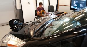 Researcher William Wilson views readouts on a Nissan Leaf EV in the lab.