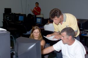 Rob Vieira teaching two students in a classroom