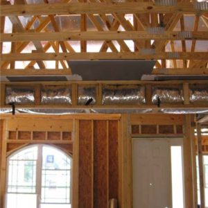 Unfinished interior of house showing trusses and ducts constructed in a dropped or "fur down"ceiling.