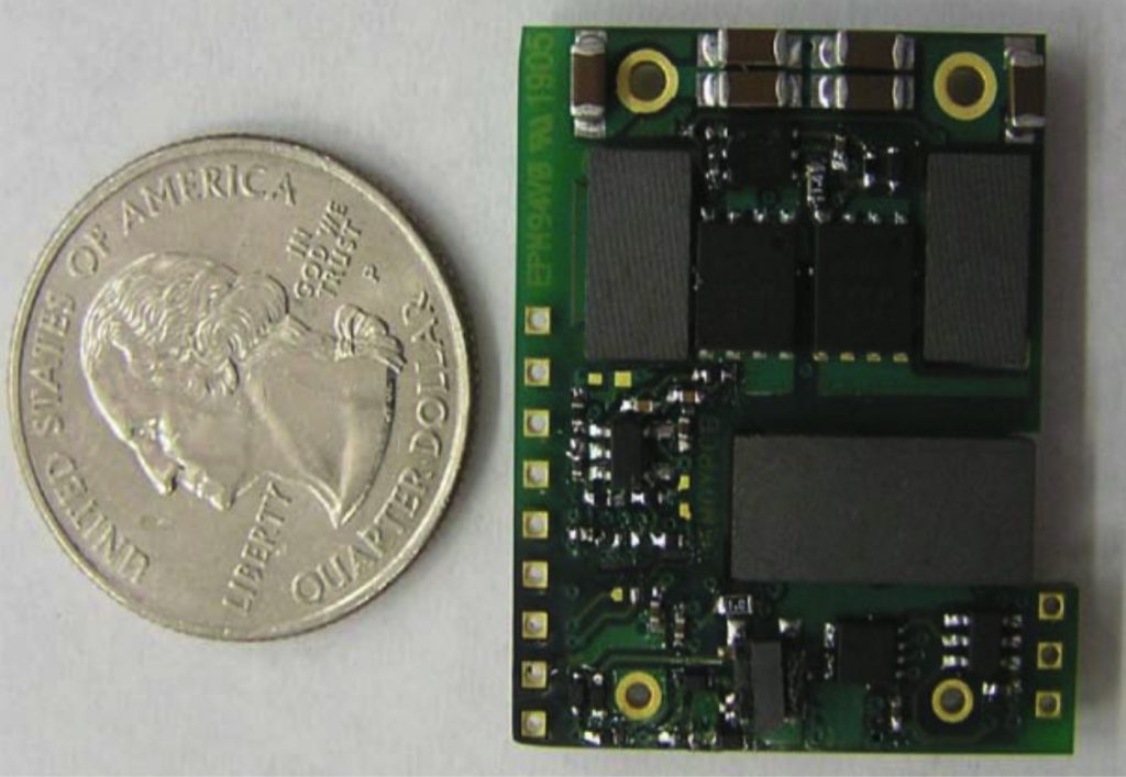 Single-chip DC to DC converter next to a quarter to indicate how small it is.