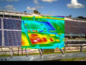 Infrared thermography image of two photovoltaic modules superimposed over photography of actual modules.