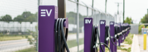 Photo of more than 10 EV chargers, purple in color, for Atom Power's fleet vehicles.